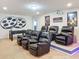 Home theater room with comfortable recliner seating, projector, and foosball table at 1614 Lima Ave, Kissimmee, FL 34747