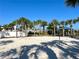 A sand volleyball court surrounded by palm trees and lush landscaping at 1614 Lima Ave, Kissimmee, FL 34747