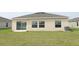 Expansive backyard with lush green grass and sliding glass doors leading inside at 165 Citrine Loop, Kissimmee, FL 34758