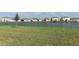Backyard view of a calm pond and other homes in the community at 165 Citrine Loop, Kissimmee, FL 34758