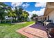 A spacious backyard features lush green grass, shed, covered patio and brick pavers at 1730 Carolyn Ct, St Cloud, FL 34769