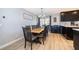 Cozy dining area with a wooden table, seating for eight, modern light fixture, and direct kitchen access at 1730 Carolyn Ct, St Cloud, FL 34769