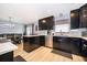 Well-equipped eat-in kitchen featuring dark cabinets, stainless steel appliances, and an adjacent dining area at 1730 Carolyn Ct, St Cloud, FL 34769