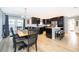 Bright and open kitchen and dining area with dark cabinets, modern appliances, and a dining table at 1730 Carolyn Ct, St Cloud, FL 34769