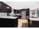 This spacious kitchen features dark cabinetry, light countertops, and stainless steel appliances at 1730 Carolyn Ct, St Cloud, FL 34769