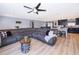 Open-concept living area with a large sectional sofa and modern decor, seamlessly flowing into the kitchen at 1730 Carolyn Ct, St Cloud, FL 34769