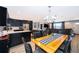 Open concept living area featuring modern light fixture, dining area, and an adjacent kitchen at 1730 Carolyn Ct, St Cloud, FL 34769