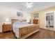 Bedroom featuring a wood frame bed, hardwood flooring and an en suite bathroom at 2060 Patriot Way, St Cloud, FL 34769