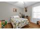 Bedroom with hardwood flooring, neutral walls, ceiling fan and a mounted deer head at 2060 Patriot Way, St Cloud, FL 34769