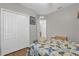 Bedroom with neutral walls, hardwood flooring, closet and two doorways at 2060 Patriot Way, St Cloud, FL 34769