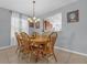 Cozy dining area with an oak dining table set, pendant lighting, and tiled flooring at 2060 Patriot Way, St Cloud, FL 34769