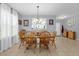 Bright dining room featuring a natural wood dining set, light-colored walls, and tile floors at 2060 Patriot Way, St Cloud, FL 34769