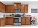 Well-equipped kitchen with stainless steel appliances, ample wooden cabinetry, and granite countertops at 2060 Patriot Way, St Cloud, FL 34769