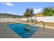 Relaxing pool area featuring clear water, patio furniture, a pergola, and a privacy fence at 2060 Patriot Way, St Cloud, FL 34769