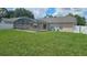 Expansive backyard featuring a screened-in pool and ample green space at 215 Grovepark Dr, Davenport, FL 33837