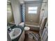 Bathroom featuring tile shower, vanity, and neutral color palette at 215 Grovepark Dr, Davenport, FL 33837