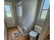 Compact bathroom with a glass-enclosed shower and natural light from the window at 215 Grovepark Dr, Davenport, FL 33837