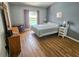 Cozy bedroom with hardwood floors and a view of the pool outside the window at 215 Grovepark Dr, Davenport, FL 33837