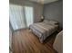 Cozy bedroom with wood-look flooring and lots of natural light at 215 Grovepark Dr, Davenport, FL 33837