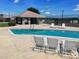 Community pool area featuring pool house and lounge chairs at 215 Grovepark Dr, Davenport, FL 33837