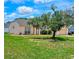 Single-story home with a well-manicured lawn and mature trees for shade at 215 Grovepark Dr, Davenport, FL 33837