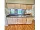 Kitchen featuring a breakfast bar, cabinets, and an open view to the backyard at 215 Grovepark Dr, Davenport, FL 33837