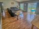 Comfortable living room with wood-look flooring and sliding glass doors to the pool area at 215 Grovepark Dr, Davenport, FL 33837