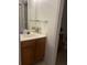 Standard bathroom with a wooden vanity, sink, and mirror; toilet area visible at 2203 San Vittorino Cir # 103, Kissimmee, FL 34741