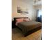 Comfortable bedroom showcasing a bed with modern art and a functional desk space at 2203 San Vittorino Cir # 103, Kissimmee, FL 34741