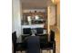 Open concept dining area adjacent to a modern kitchen with stainless steel appliances at 2203 San Vittorino Cir # 103, Kissimmee, FL 34741