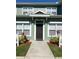 Inviting townhome entrance features a classic brown door and well-kept landscaping at 2203 San Vittorino Cir # 103, Kissimmee, FL 34741
