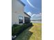 Lush backyard featuring a well-manicured lawn and picturesque views of the tranquil pond at 2289 Seven Oaks Dr, St Cloud, FL 34772