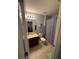 Bathroom featuring a vanity with dark wood cabinets, a toilet, and a shower with blue patterned curtain at 2289 Seven Oaks Dr, St Cloud, FL 34772