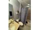 Bright bathroom with vanity and light countertop, toilet, and tub with shower and colorful curtain at 2289 Seven Oaks Dr, St Cloud, FL 34772