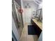 Bathroom with tiled floors, enclosed shower, vanity with dual sinks, and decorative wall art at 2289 Seven Oaks Dr, St Cloud, FL 34772