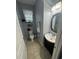 Half bath with tiled floors, vanity, and decorative wall mirror at 2289 Seven Oaks Dr, St Cloud, FL 34772
