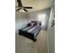 Cozy bedroom with neutral walls, ceiling fan, and a patterned comforter set at 2289 Seven Oaks Dr, St Cloud, FL 34772