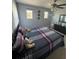 Bedroom with neutral walls, ceiling fan, and a patterned comforter set at 2289 Seven Oaks Dr, St Cloud, FL 34772
