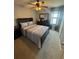 Bedroom featuring a queen bed, dresser, and view of a window overlooking a lake at 2289 Seven Oaks Dr, St Cloud, FL 34772