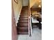 Entryway with wood stairs leading to a kitchen area featuring a breakfast bar at 2289 Seven Oaks Dr, St Cloud, FL 34772
