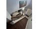 View from the top of the stairs looking into a brightly lit living room and front door entry at 2289 Seven Oaks Dr, St Cloud, FL 34772