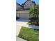 Charming townhome featuring a well-manicured lawn, two car garage and lovely landscaping at 2289 Seven Oaks Dr, St Cloud, FL 34772