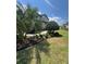 Beautiful landscaping with vibrant bromeliads and palm trees enhances this home's curb appeal at 2289 Seven Oaks Dr, St Cloud, FL 34772