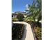 This well maintained front yard has lovely mature palm trees and beautiful landscaping at 2289 Seven Oaks Dr, St Cloud, FL 34772