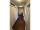 Hallway with beautiful laminate wood flooring, closets and multiple doorways for access at 2289 Seven Oaks Dr, St Cloud, FL 34772