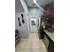 Galley kitchen featuring stainless steel appliances, tile floors, and granite countertops at 2289 Seven Oaks Dr, St Cloud, FL 34772