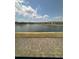 Picturesque view of a lake surrounded by houses, showing the appealing neighborhood setting at 2289 Seven Oaks Dr, St Cloud, FL 34772