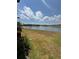 Scenic view of the pond with a fountain, surrounded by well-manicured landscaping and homes at 2289 Seven Oaks Dr, St Cloud, FL 34772