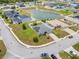 Neighborhood aerial view showcasing a home's solar panels near pond, green space and community at 233 E Cattail, Lake Alfred, FL 33850