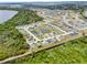 Aerial view of community, showcasing a network of homes, a large pond, and nature reserve at 233 E Cattail, Lake Alfred, FL 33850